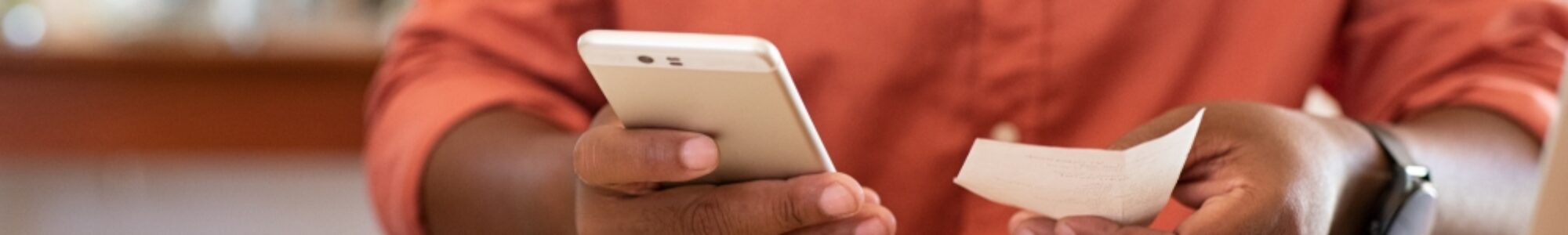 Closeup of man hands using phone to calculate expenses. Man checking invoice balance on mobile phone app. Close up hands of guy taking a closer look at his budget and calculating credit card bills.